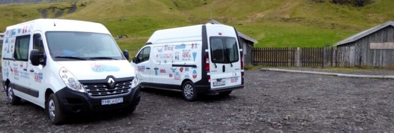 two rent.is camper vans parked in a parkinglot
