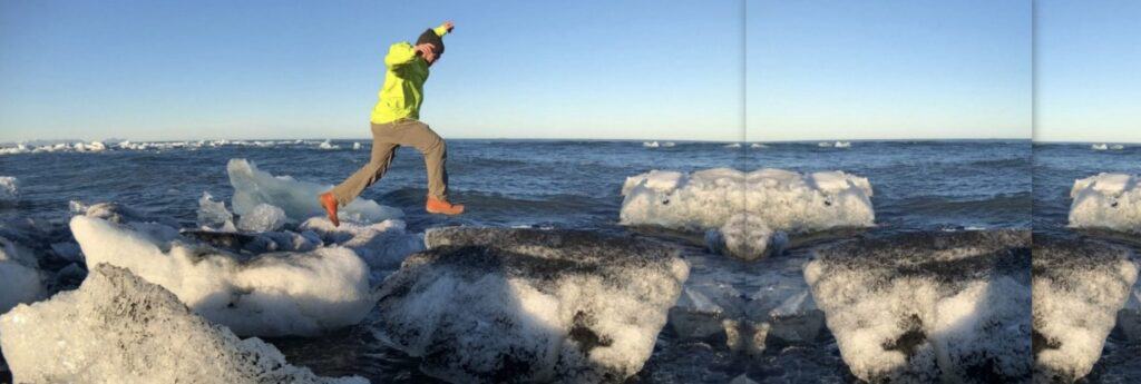 Man jumping on icebergs in the sea