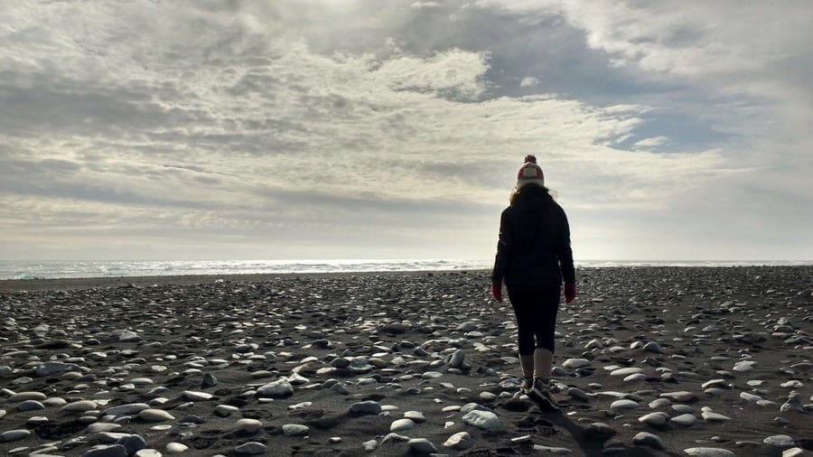 Walking on a black sand beach