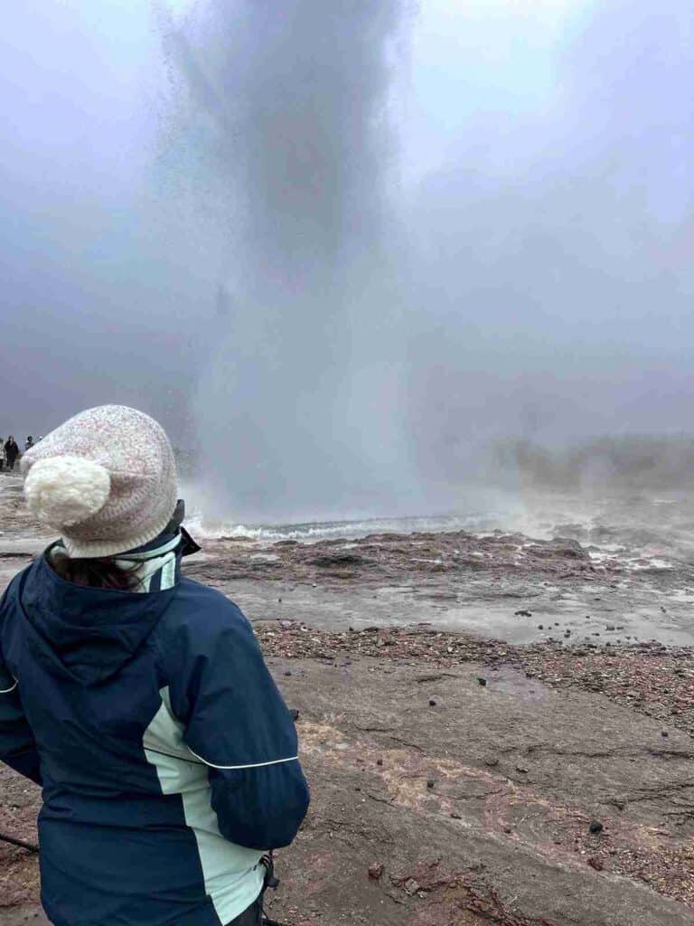 A woman looking at Geysir