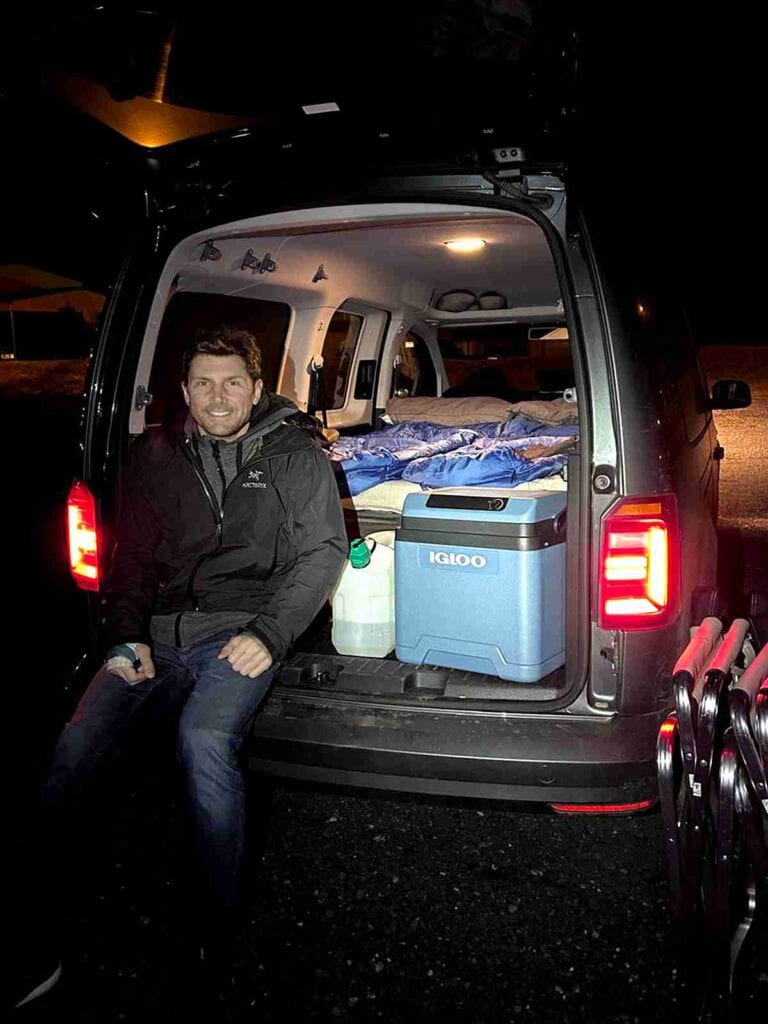 A man sitting in the trunk of the campervan